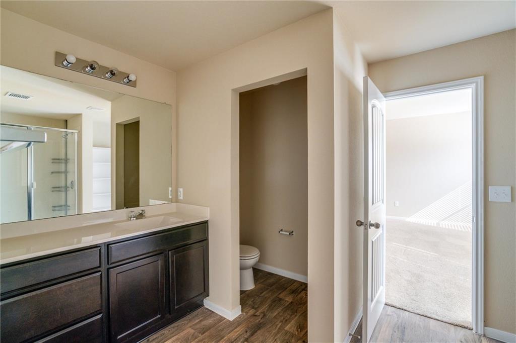 11704 Andesite Road Manor, TX 78653 - Photo 19 of 30 a bathroom with a sink and a mirror