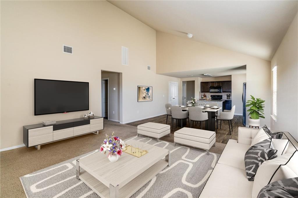 11704 Andesite Road Manor, TX 78653 - Photo 2 of 30 a living room with furniture and a flat screen tv