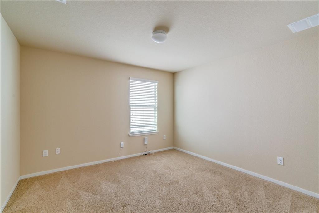 11704 Andesite Road Manor, TX 78653 - Photo 20 of 30 an empty room with a window