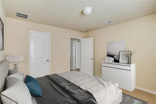 a bedroom with a bed and painting on the wall