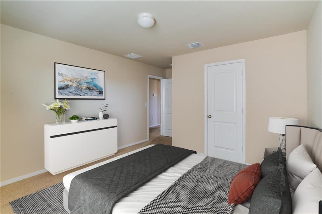 11704 Andesite Road Manor, TX 78653 - Photo 5 of 30 a bedroom with a bed and a couch