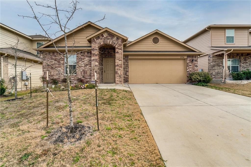 11704 Andesite Road Manor, TX 78653 - Photo 7 of 30 a front view of a house with garden