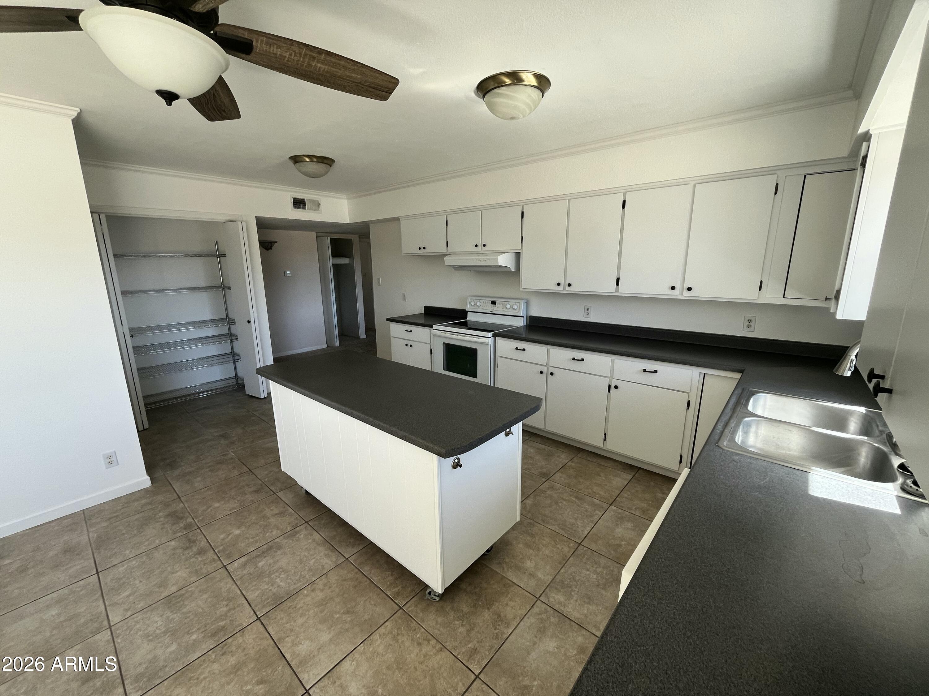 490 South 9th Street Globe, AZ 85501 - Photo 21 of 45 a kitchen with stainless steel appliances granite countertop a sink and a stove