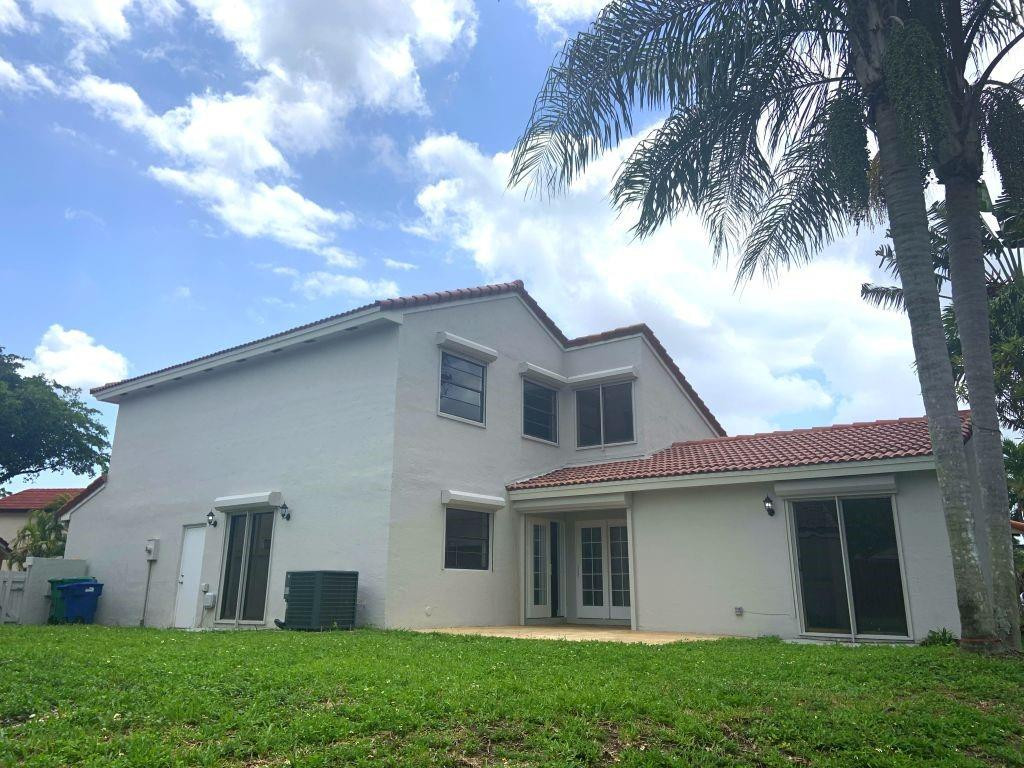 6376 Northwest 173rd Street Hialeah, FL 33015 - Photo 11 of 20 a view of a house with a yard