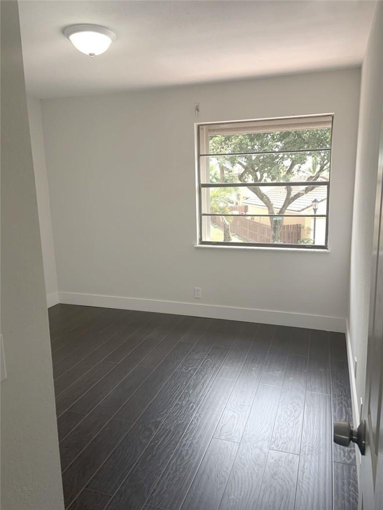 6376 Northwest 173rd Street Hialeah, FL 33015 - Photo 15 of 20 an empty room with wooden floor and windows