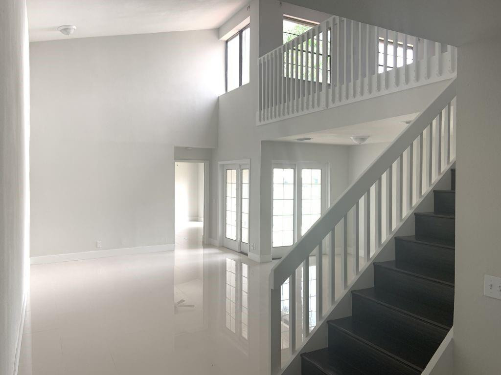 6376 Northwest 173rd Street Hialeah, FL 33015 - Photo 18 of 20 a view of staircase with railing and a chandelier