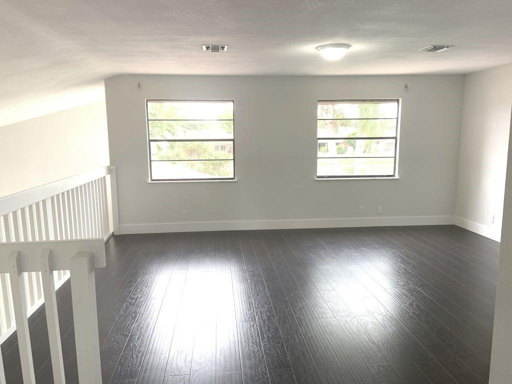 6376 Northwest 173rd Street Hialeah, FL 33015 - Photo 3 of 20 an empty room with wooden floor and windows