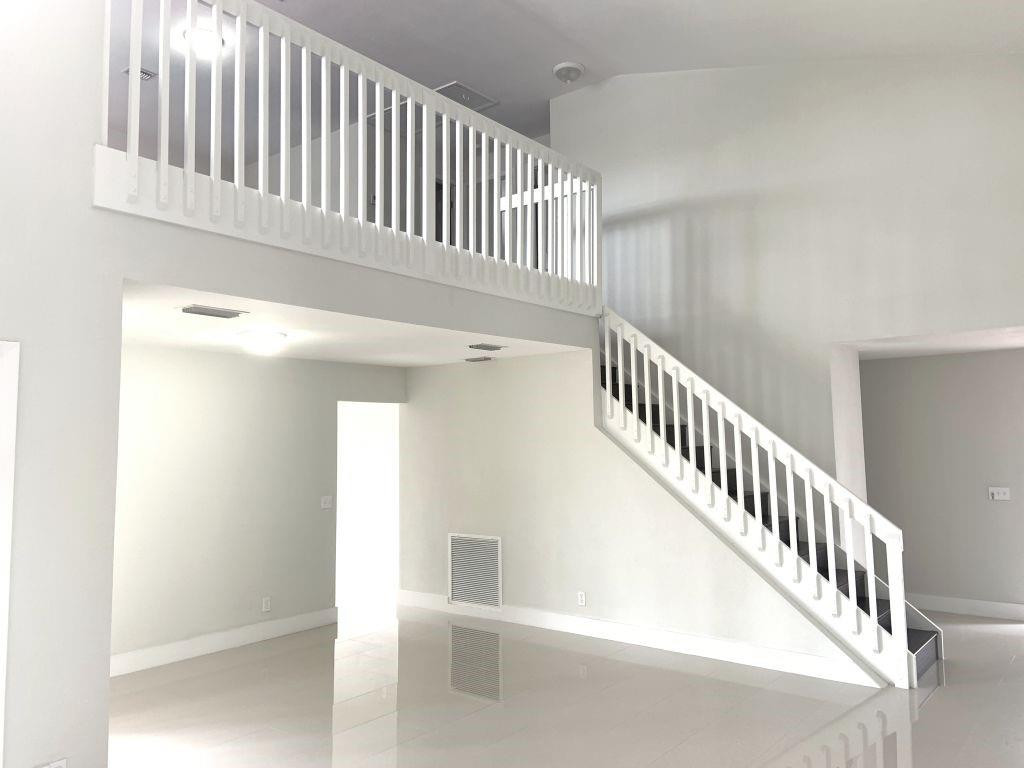 6376 Northwest 173rd Street Hialeah, FL 33015 - Photo 5 of 20 a view of staircase with white walls and a window