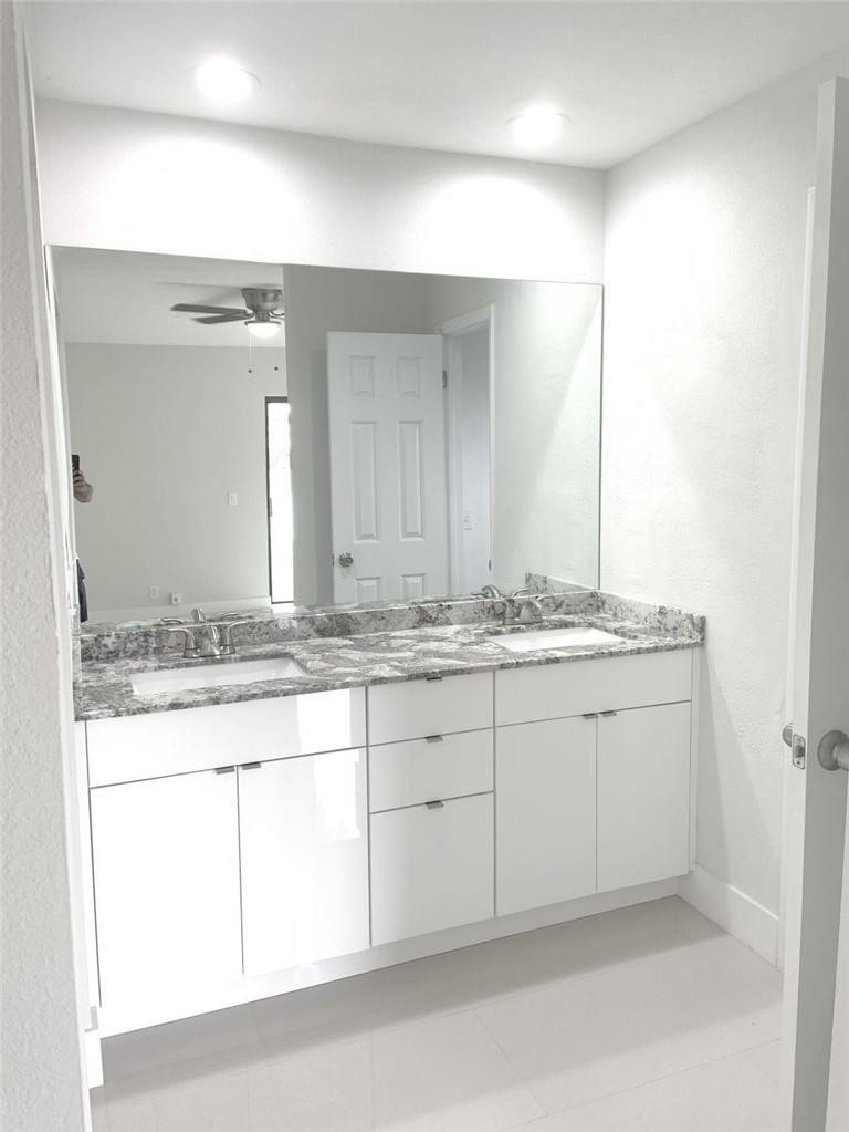 6376 Northwest 173rd Street Hialeah, FL 33015 - Photo 6 of 20 a bathroom with a granite countertop sink and a mirror