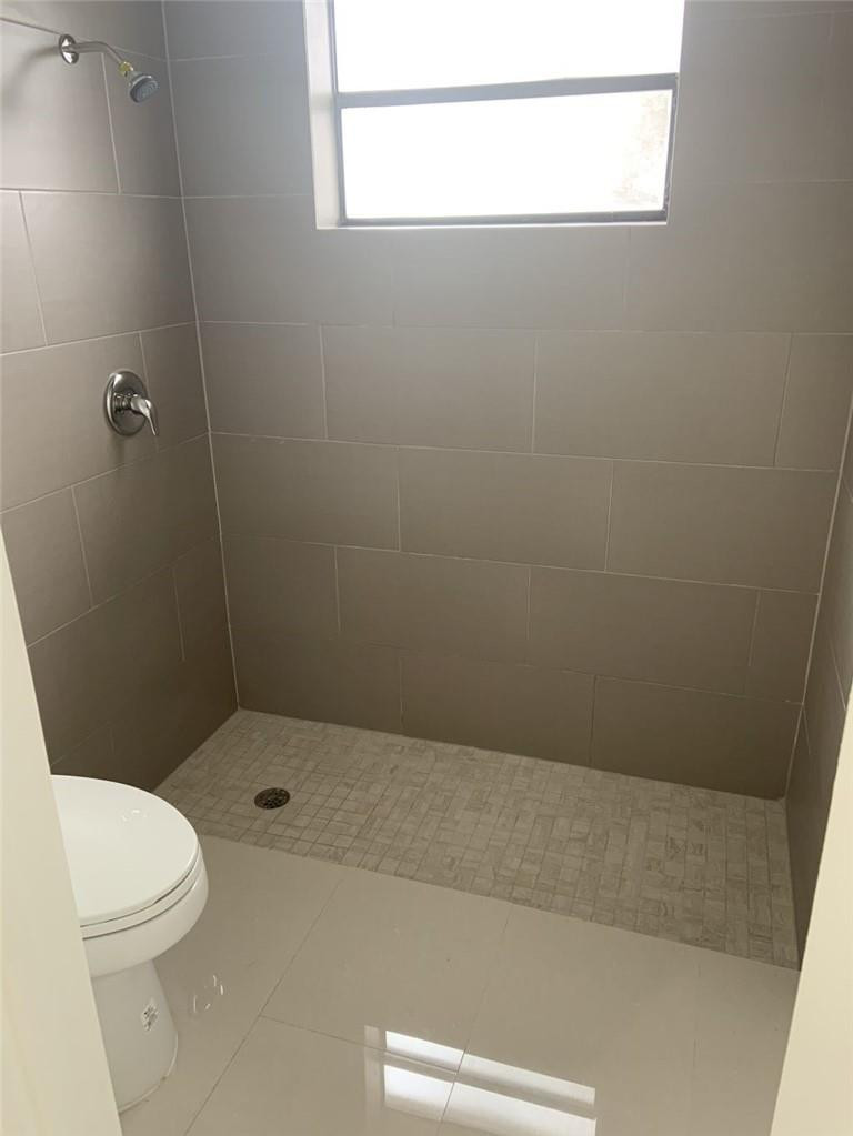 6376 Northwest 173rd Street Hialeah, FL 33015 - Photo 7 of 20 a bathroom with a toilet a sink and a shower