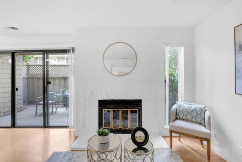 a living room with furniture a dining table and a fireplace