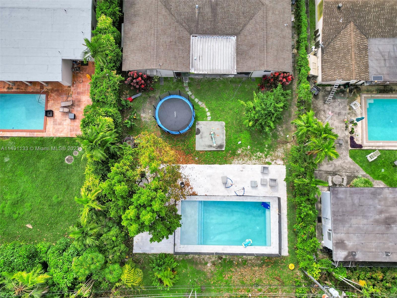 an aerial view of a house with a yard and a garden