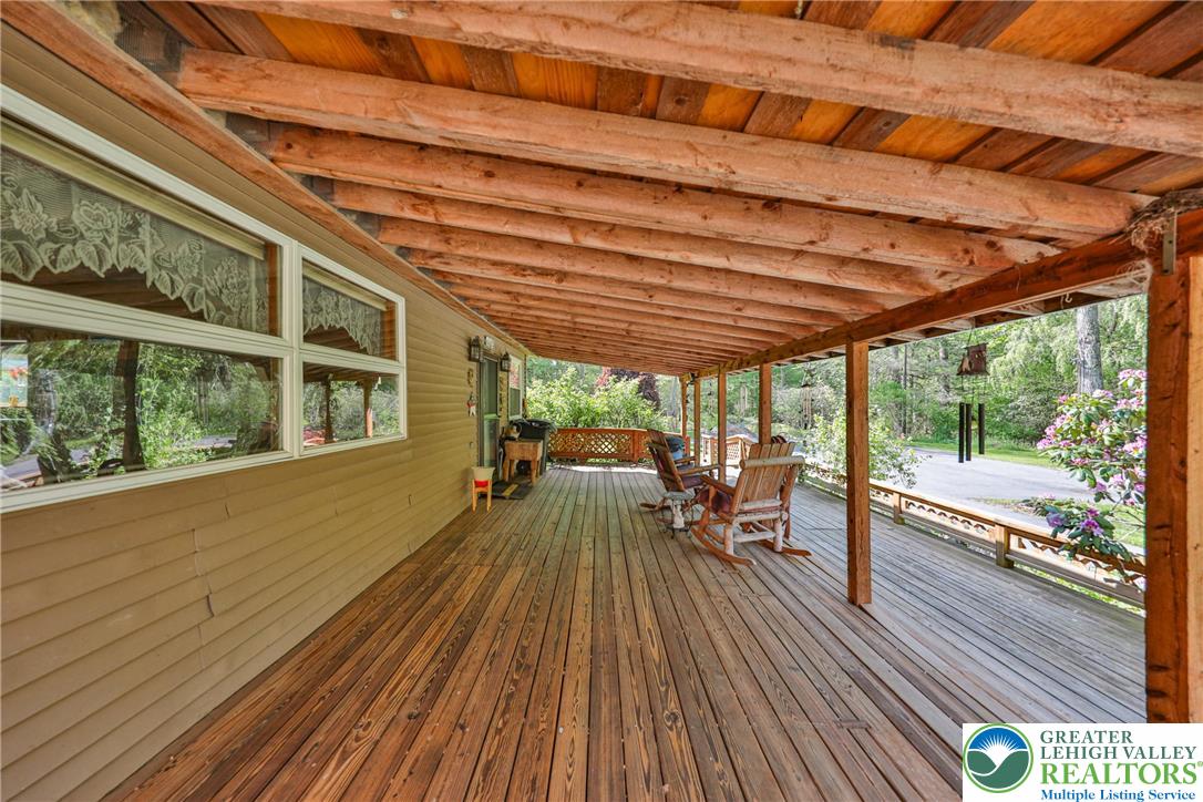 331 Cranberry Creek Road Cresco, PA 18326 - Photo 85 of 95 An inviting covered porch extends a warm welcome, offering a comfortable space for outdoor enjoyment.