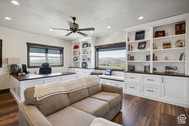 6117 North Rocky Ridge Road Peoa, UT 84061 - Photo 49 of 83 Living room with ceiling fan, dark hardwood / wood-style flooring, and a textured ceiling