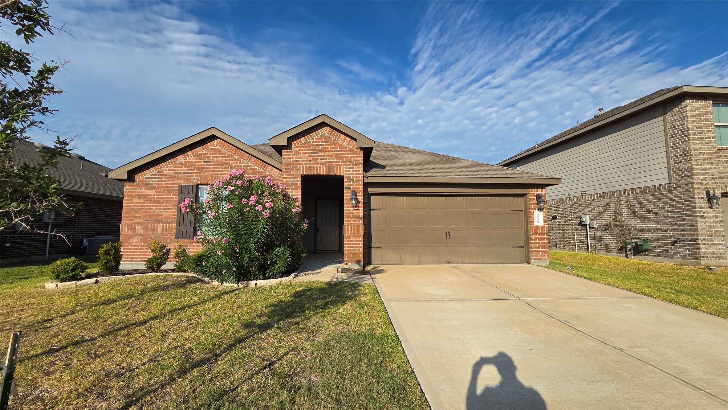 a front view of house with yard and garage
