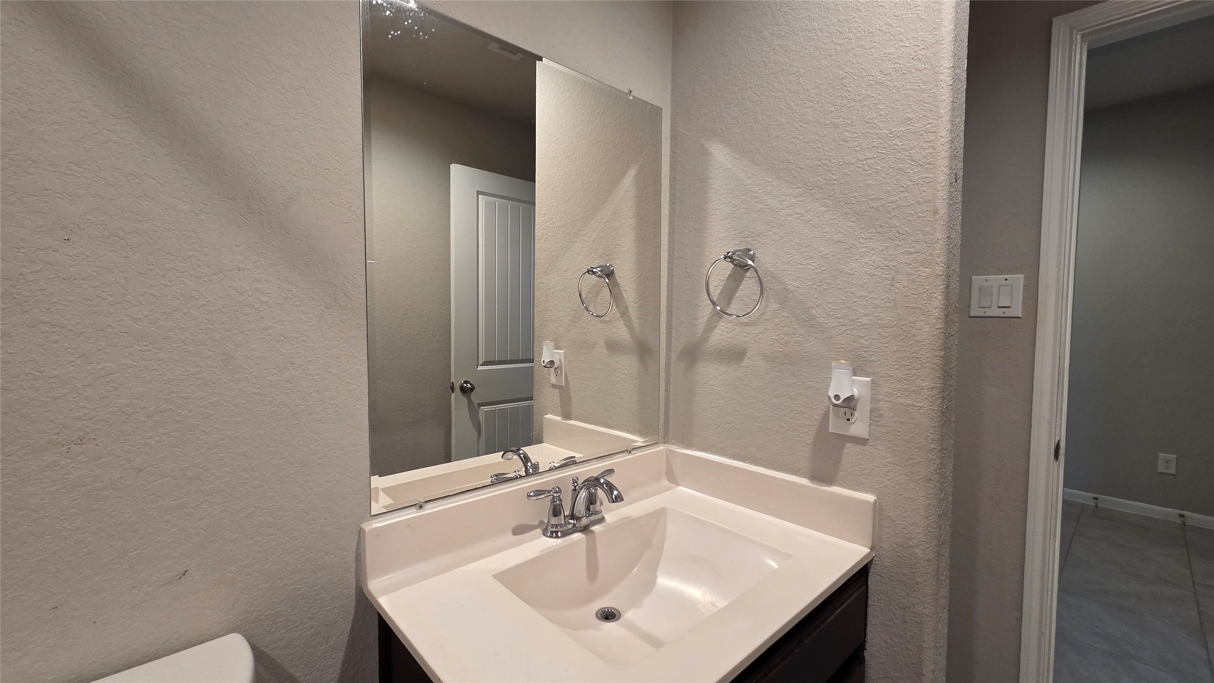 3518 Windham Way Katy, TX 77494 - Photo 16 of 18 a bathroom with a sink and a mirror
