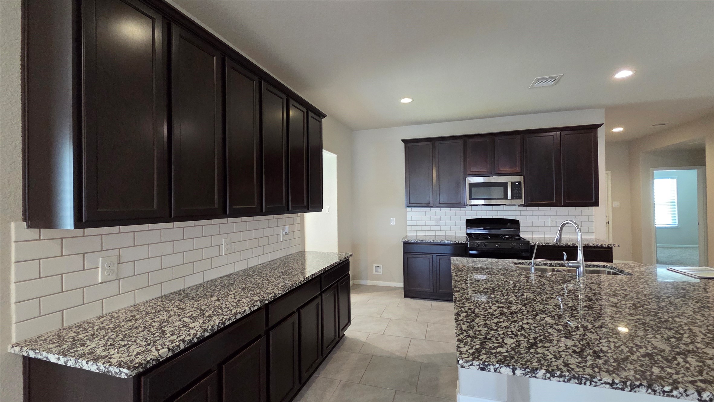 3518 Windham Way Katy, TX 77494 - Photo 5 of 18 a kitchen with granite countertop wooden cabinets and stainless steel appliances