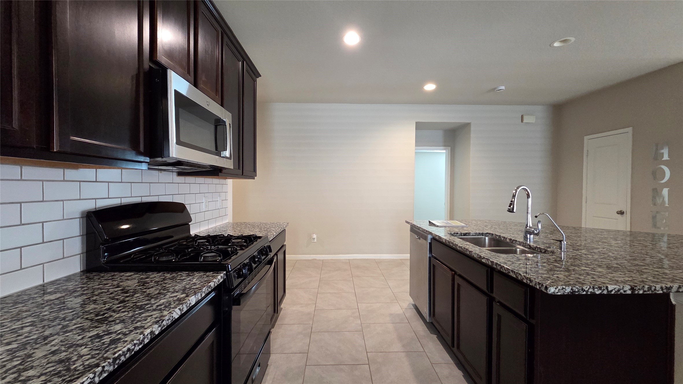 3518 Windham Way Katy, TX 77494 - Photo 6 of 18 a kitchen with stainless steel appliances granite countertop a sink stove and cabinets