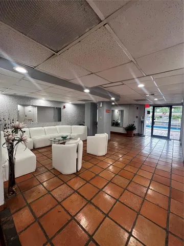 a room with lots of furniture and white walls