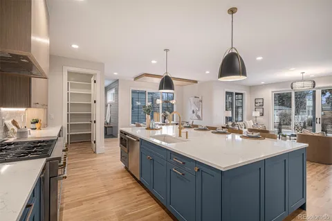 a kitchen with a stove sink and cabinets