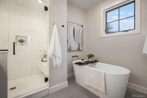 a white bath tub sitting next to a shower