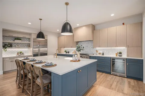 a kitchen with a sink a stove a dining table and chairs