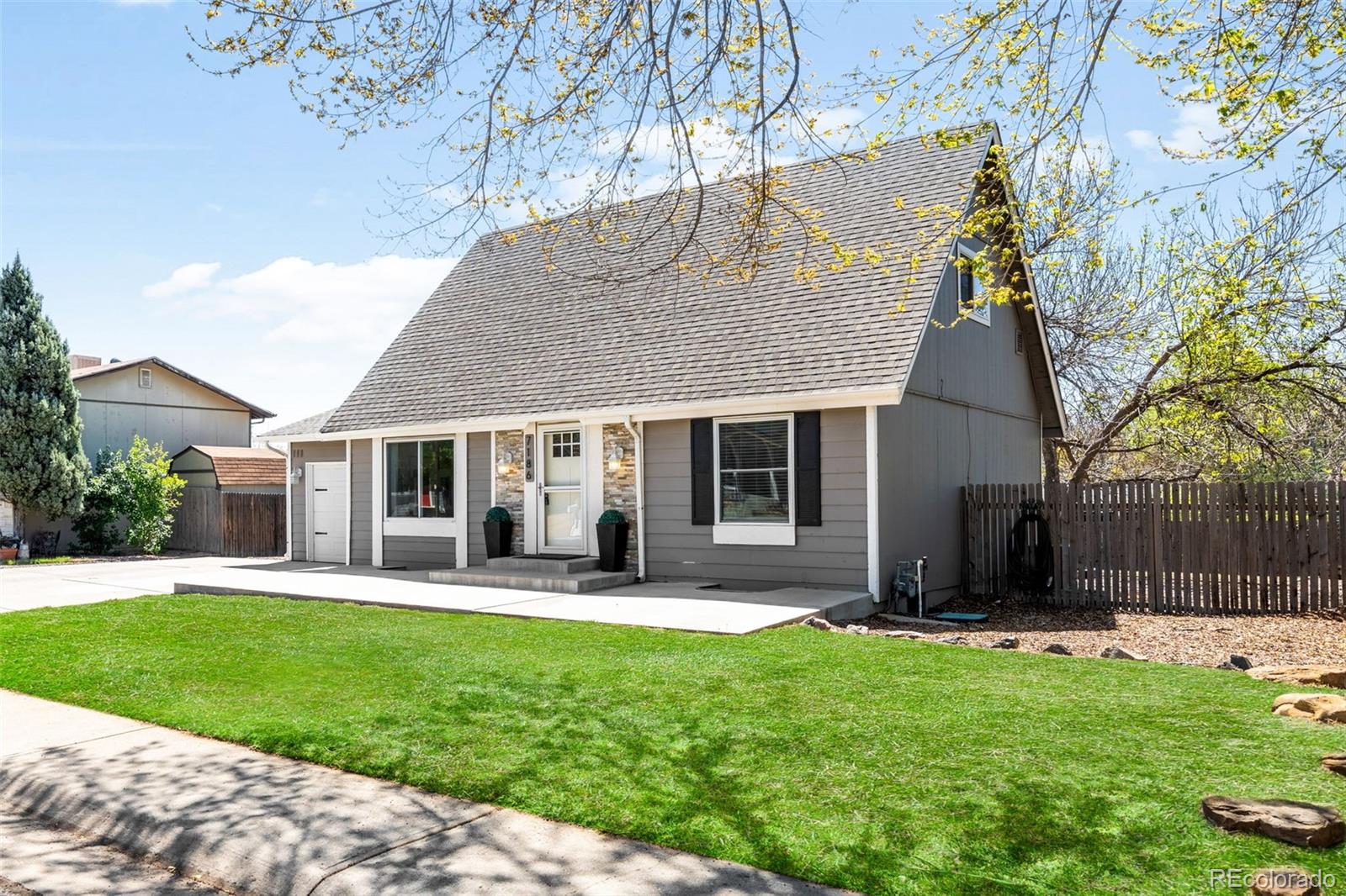 7186 West 79th Drive Arvada, CO 80003 - Photo 1 of 43 a front view of house with a garden and patio