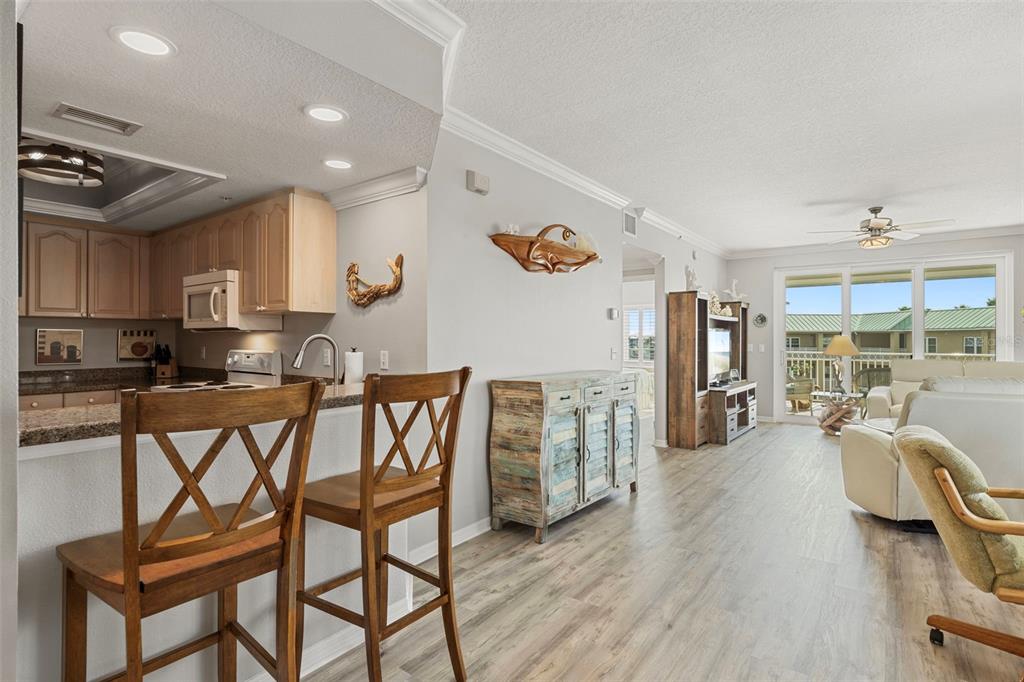 399 150th Avenue, Unit 309 Madeira Beach, FL 33708 - Photo 12 of 43 a view of a dining room with furniture and a large window