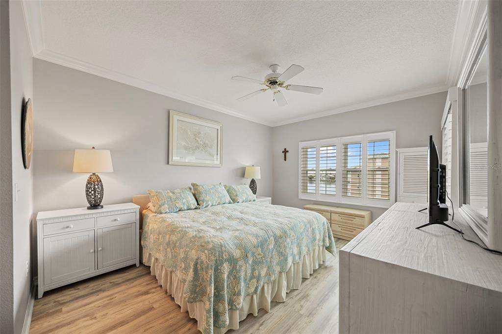 399 150th Avenue, Unit 309 Madeira Beach, FL 33708 - Photo 13 of 43 a bedroom with a bed and a large window