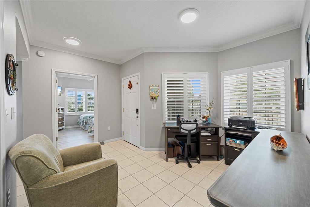 399 150th Avenue, Unit 309 Madeira Beach, FL 33708 - Photo 17 of 43 a living room with furniture and a large window
