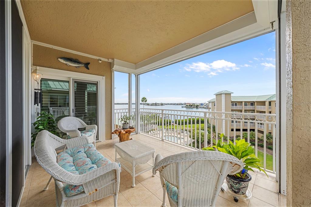 399 150th Avenue, Unit 309 Madeira Beach, FL 33708 - Photo 24 of 43 a balcony with furniture and a potted plant