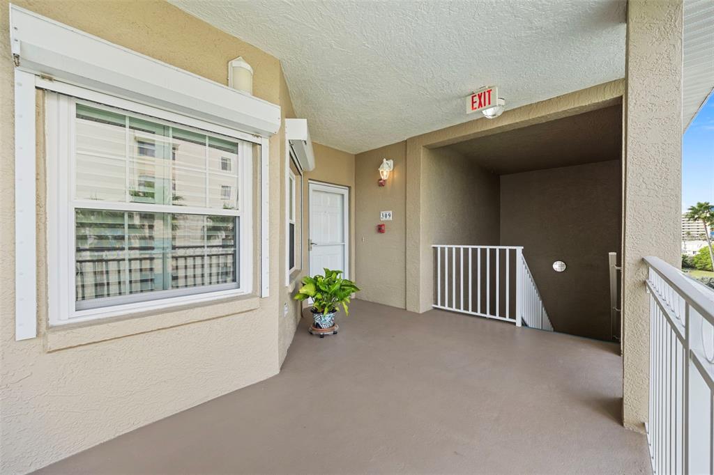 399 150th Avenue, Unit 309 Madeira Beach, FL 33708 - Photo 26 of 43 a view of an entryway door with a porch