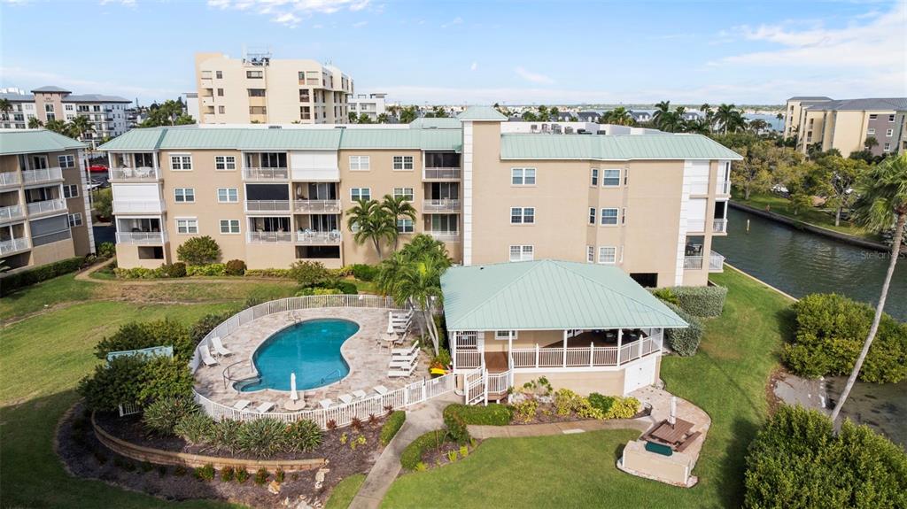 399 150th Avenue, Unit 309 Madeira Beach, FL 33708 - Photo 4 of 43 an aerial view of residential houses with outdoor space and swimming pool