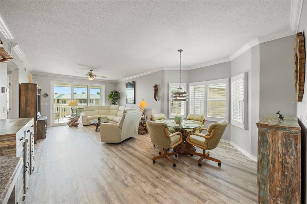 399 150th Avenue, Unit 309 Madeira Beach, FL 33708 - Photo 5 of 43 a living room with furniture and a wooden floor