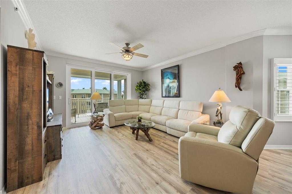 399 150th Avenue, Unit 309 Madeira Beach, FL 33708 - Photo 6 of 43 a living room with furniture and a large window