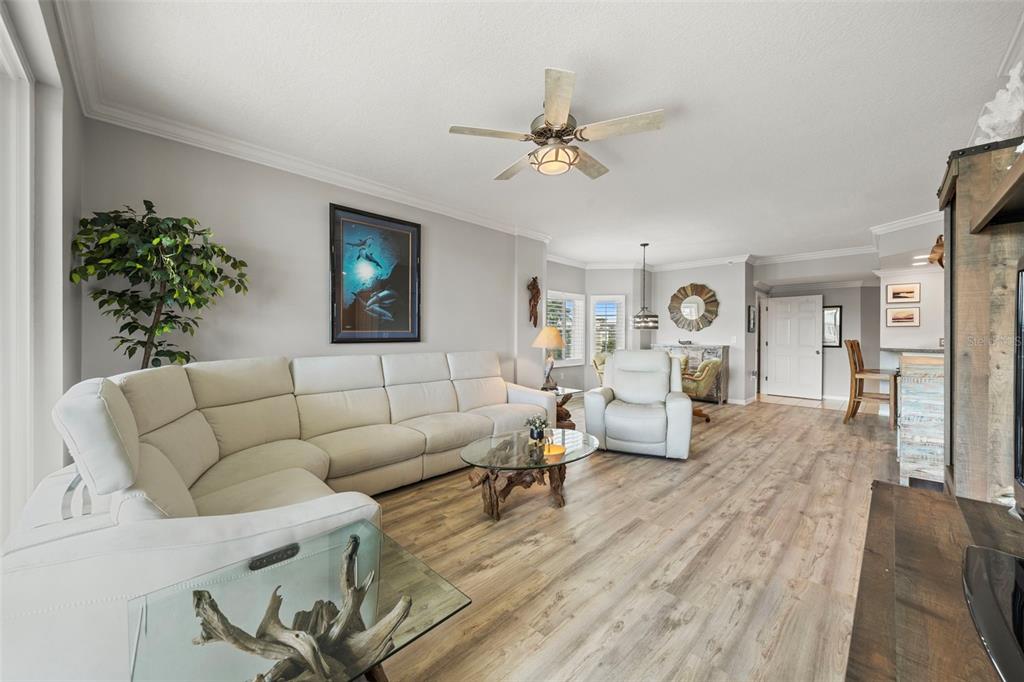 399 150th Avenue, Unit 309 Madeira Beach, FL 33708 - Photo 7 of 43 a living room with furniture and wooden floor