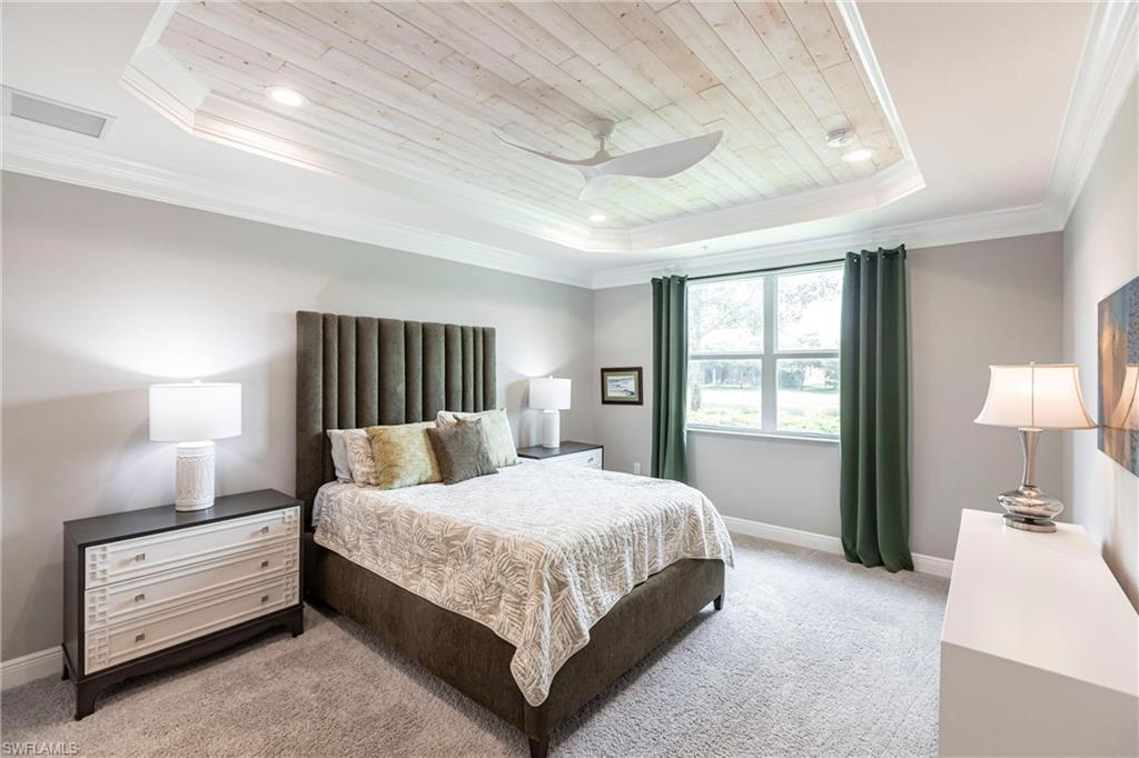 2319 Sawyers Hill Road, Unit 703 Naples, FL 34120 - Photo 15 of 35 a bedroom with a bed and a night stand