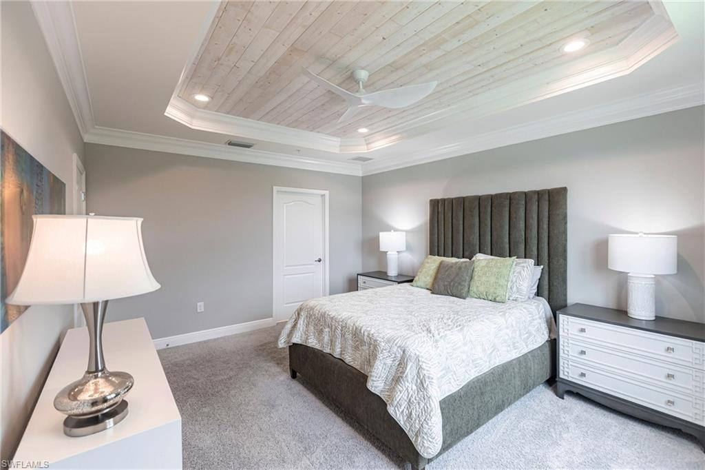 2319 Sawyers Hill Road, Unit 703 Naples, FL 34120 - Photo 18 of 35 a bedroom with a bed and a lamp