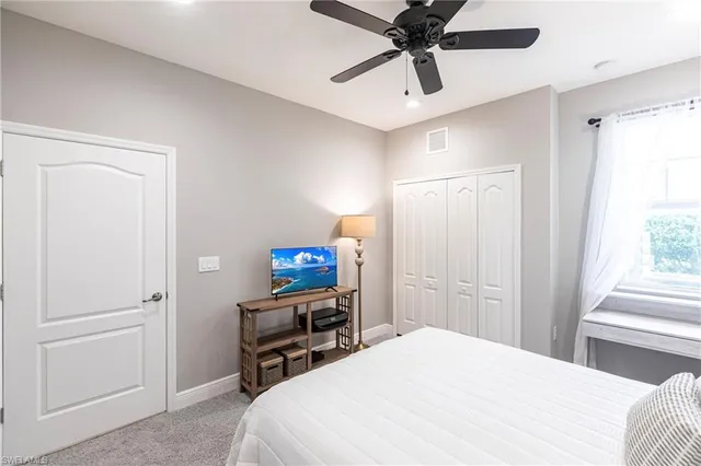 a bedroom with a bed and a tv on the dresser