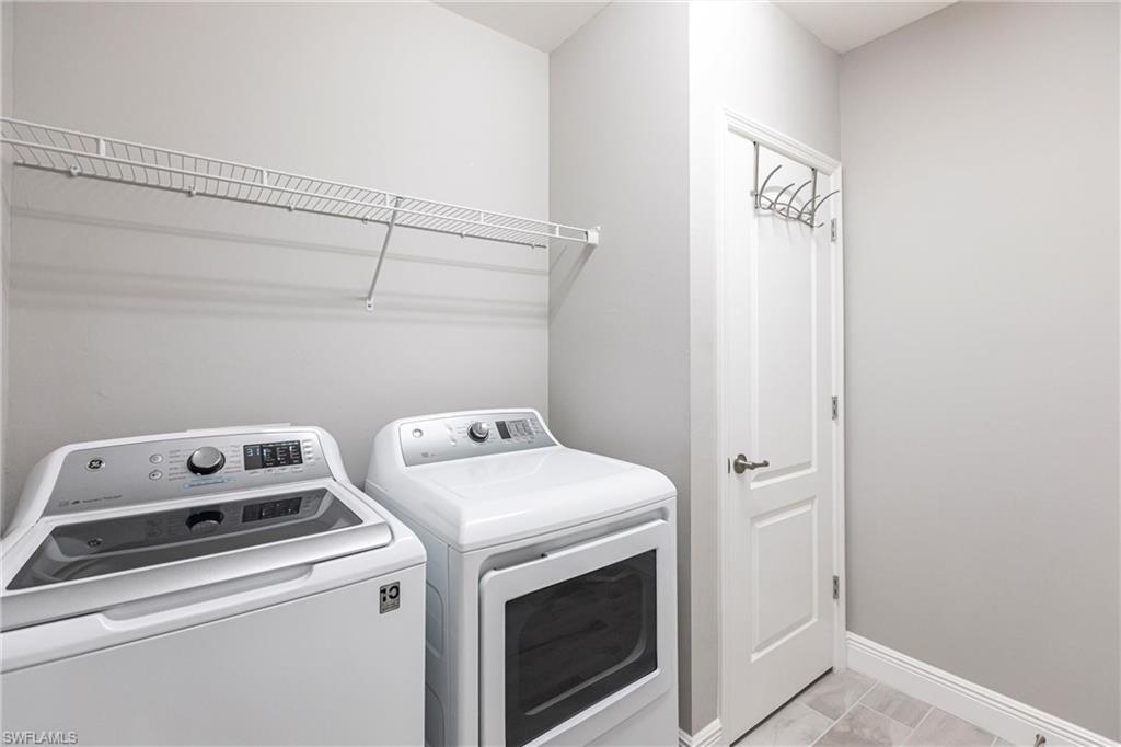 2319 Sawyers Hill Road, Unit 703 Naples, FL 34120 - Photo 27 of 35 a utility room with dryer and washer