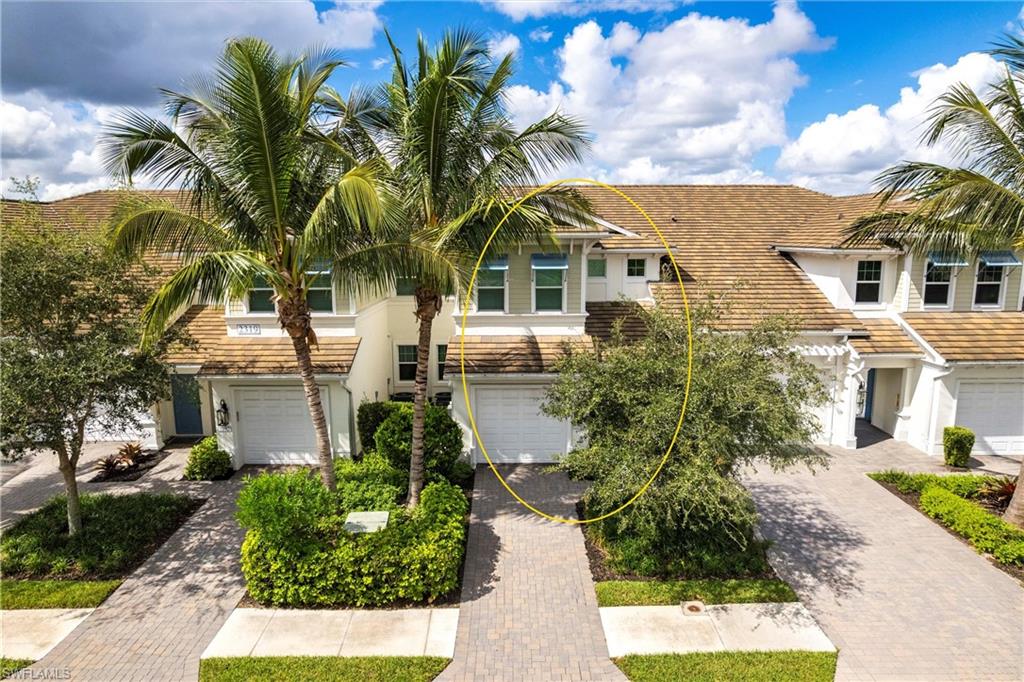 2319 Sawyers Hill Road, Unit 703 Naples, FL 34120 - Photo 32 of 35 a view of a white house with a yard and potted plants