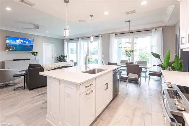 a large white kitchen with a large window