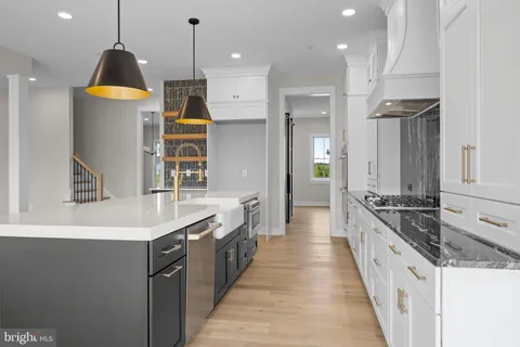 a kitchen with granite countertop a stove and a sink