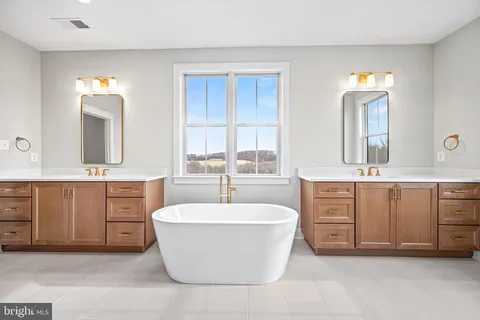 a bathroom with a glass door shower a sink and a mirror