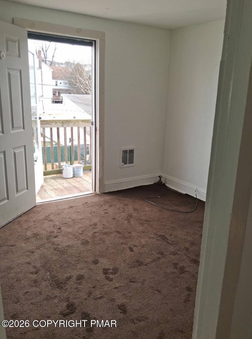 520 Hickory Street, Unit 3 Scranton, PA 18505 - Photo 4 of 10 an empty room with a fireplace