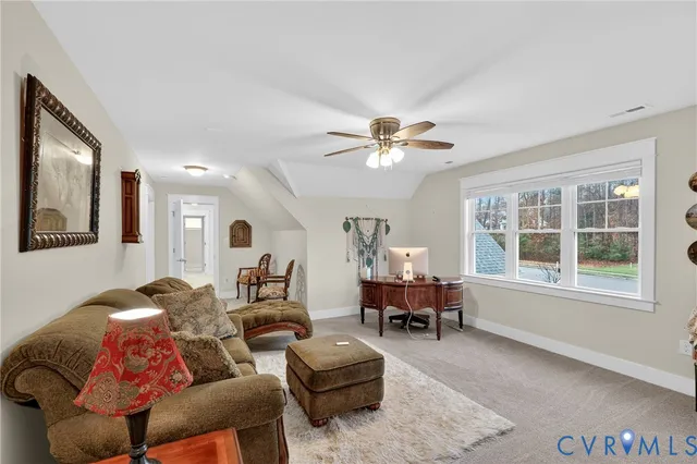 a living room with furniture and two window