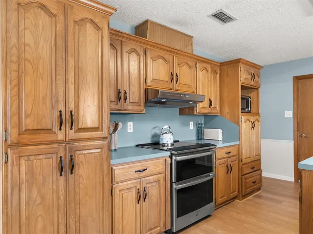 a kitchen with stainless steel appliances granite countertop a stove and a refrigerator