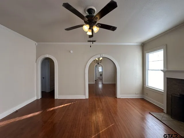 a view of entryway and hall with wooden floor