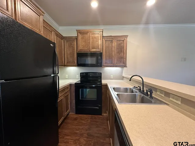 an empty room with wooden floor closet and windows