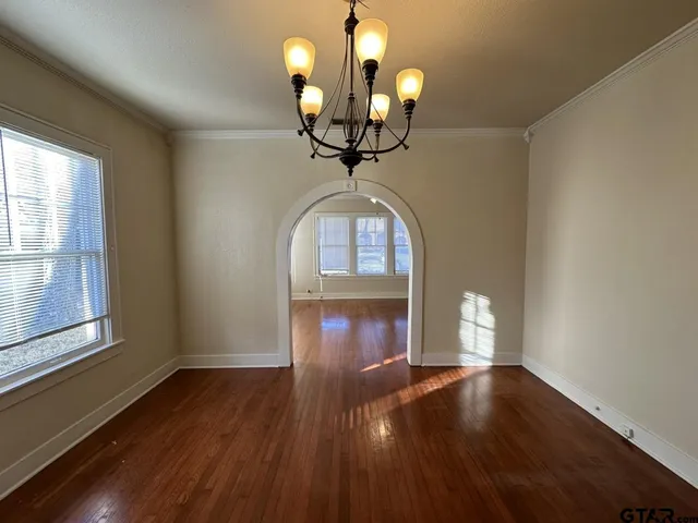 a view of a room with wooden floor fan and window